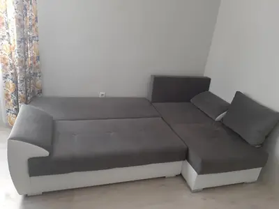 a couch with two pillows on it in a room at Sea & chill suite in Burgas City