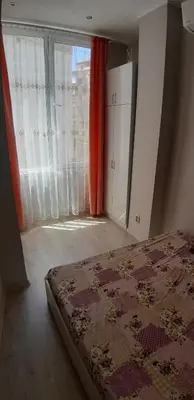 a bedroom with a bed and a large window at Sea & chill suite in Burgas City