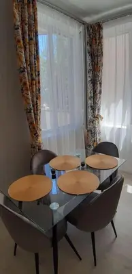 a dining room table with four chairs and a glass table at Sea & chill suite in Burgas City