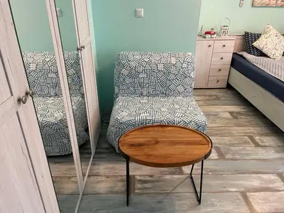 a bedroom with a chair and a bed at Bright 1BD Apartment with Nice Terrace by Flat Mаnаger in Burgas City