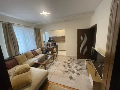 a living room with a couch and a table at Apartment The Room in Burgas City