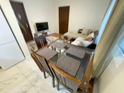 a living room with a table and chairs and a couch at Apartment The Room in Burgas City
