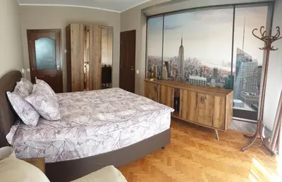 a bedroom with a bed and a large window at Apartment The Room in Burgas City
