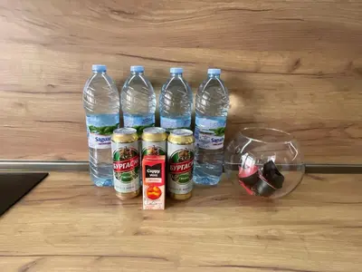 a group of water bottles sitting on top of a wooden floor at Apartment The Room in Burgas City