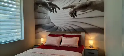 a bedroom with a bed with a painting on the wall at Нава 8 in Burgas City