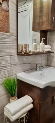 a bathroom with a sink and a mirror at Нава 8 in Burgas City