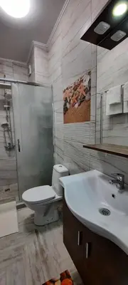 a bathroom with a toilet and a sink at Нава 8 in Burgas City