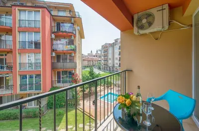 a balcony with a table and a view of a building at Sunny View Central Holiday Apartments in Sunny Beach