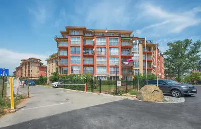 a parking lot in front of a large building at Sunny View Central Holiday Apartments in Sunny Beach
