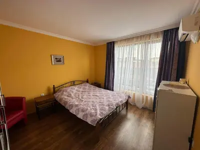 a small bedroom with a bed and a window at Sirena in Sveti Vlas