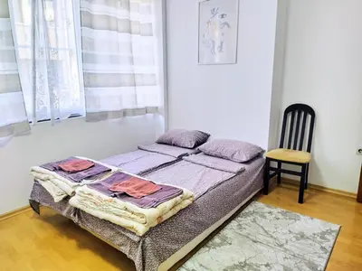 a small bed in a room with a chair at SUPER CENTER - Small Flat on 