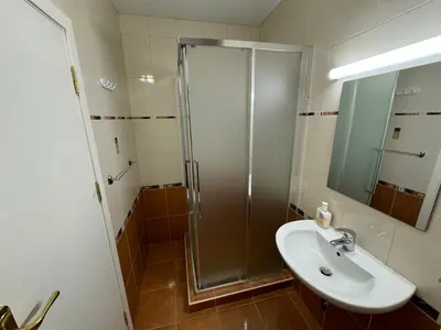 a bathroom with a shower and a sink at Amrita apartments Nessebar in Nesebar