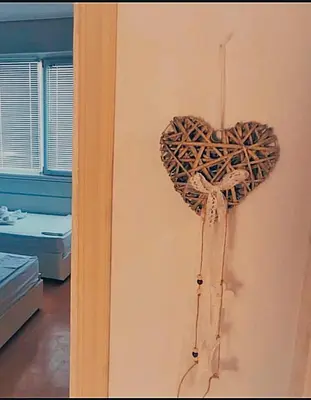 a heart hanging on a wall in a room at Апартамент Арена Бургас in Burgas City
