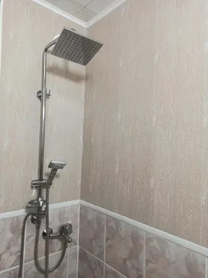 a shower with a shower head in a bathroom at Апартамент Арена Бургас in Burgas City