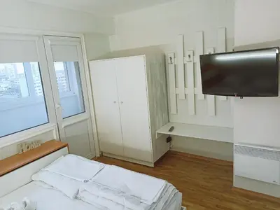 a small room with a bed and a flat screen tv at Апартамент Арена Бургас in Burgas City