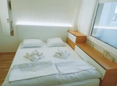 a bedroom with a bed with towels on it at Апартамент Арена Бургас in Burgas City