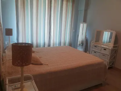a bedroom with a bed and a television at Lilly apartment Pomorie in Pomorie