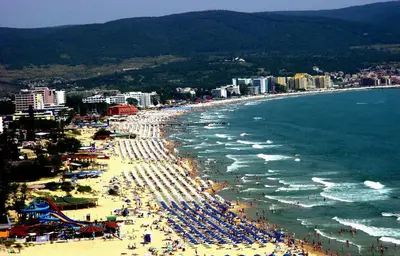 a beach with a lot of people and the ocean at Apolon 8 Relax Studio with Pools in Sunny Beach