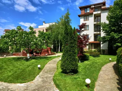 a garden in front of a building at Apolon 8 Relax Studio with Pools in Sunny Beach