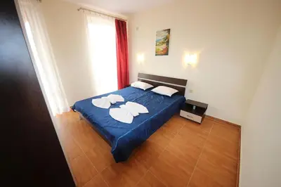 a bedroom with a blue bed with two towels on it at Paradise Dreams - Bulharske More - Sveti Vlas in Sveti Vlas