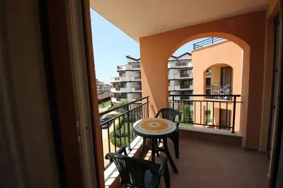 a balcony with a table and chairs on a balcony at Paradise Dreams - Bulharske More - Sveti Vlas in Sveti Vlas