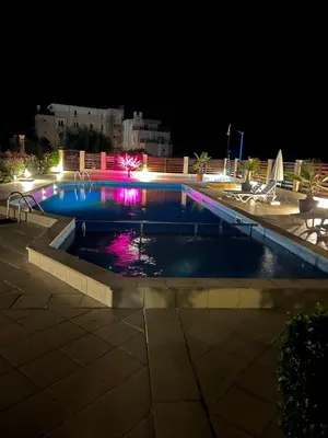 a swimming pool at night with lights at Fortuna Cape-Byala SP apartments in Byala