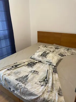 a bed with a comforter on top of it at Fortuna Cape-Byala SP apartments in Byala