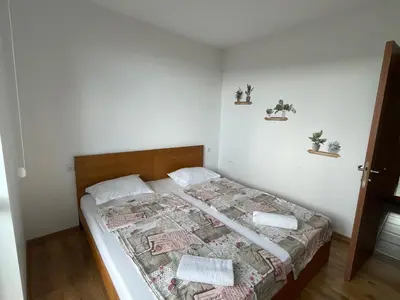 a bedroom with a bed with a quilt on it at Fortuna Cape-Byala SP apartments in Byala