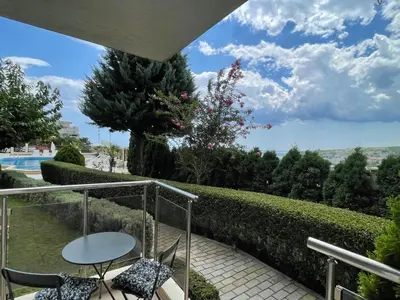 a patio with a table and chairs on a balcony at Fortuna Cape-Byala SP apartments in Byala