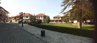 a cobblestone street in a residential neighborhood with houses at Глобал вил in Sunny Beach