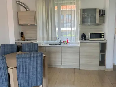 a small kitchen with a sink and a microwave at Fenix Apart Complex in Sveti Vlas