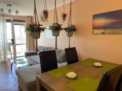 a living room with a wooden table and a dining room at VIP Style private apartments in Elenite