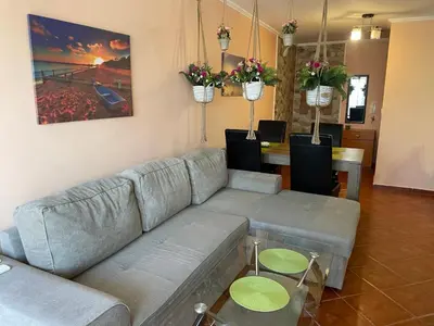 a living room with a couch and a table at VIP Style private apartments in Elenite