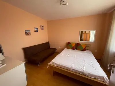 a small bedroom with a bed and a couch at VIP Style private apartments in Elenite