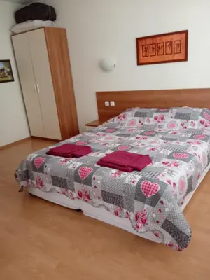 a bedroom with a bed with a quilt on it at Big comfortable apartment with 2 bedrooms Pollo Resort Sunny Beach in Sunny Beach