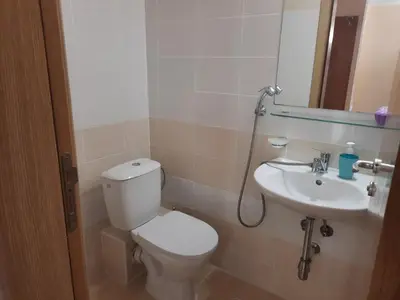 a bathroom with a toilet and a sink at Big comfortable apartment with 2 bedrooms Pollo Resort Sunny Beach in Sunny Beach
