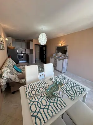 a dining room and living room with a table and chairs at Bryan