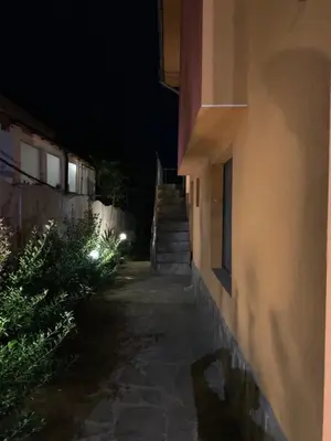 a stairway leading up to a building at night at Апартамент Нели in Ravadinovo