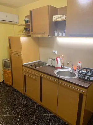 a kitchen with a sink and a counter top at Апартамент Нели in Ravadinovo