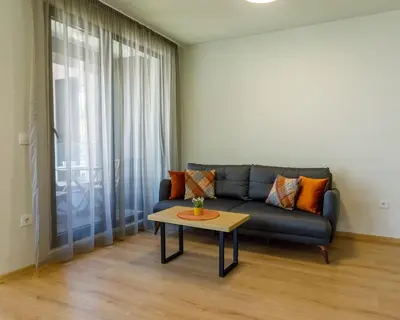 a living room with a couch and a coffee table at Kraimorie Park in Burgas City