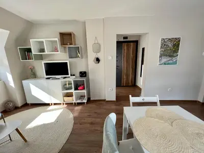 a living room with a couch and a table with a tv at Dockview atelier in Burgas City