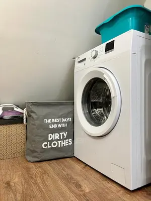 a washing machine with a pillow next to it at Dockview atelier in Burgas City