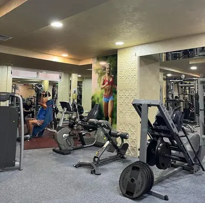 a gym with several treadmills and machines in it at Atlantis Resort D111 апартамент in Burgas City