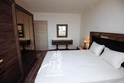 a bedroom with a large white bed with a desk at Modern Spacious 1BD Apartment for two in Nesebar by Flat Mаnаger in Nesebar