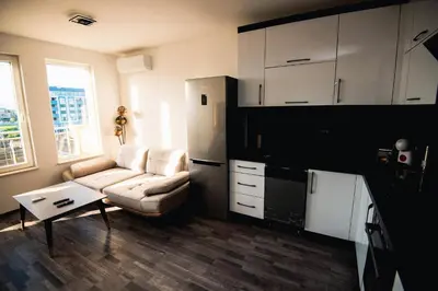 a living room with a couch and a table at Modern Spacious 1BD Apartment for two in Nesebar by Flat Mаnаger in Nesebar