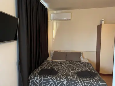a bedroom with a bed with two pillows on it at Bella Apartment - Holiday Complex Rainbow in Sunny Beach