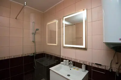a bathroom with a sink and a mirror and a shower at Romantic Getaway 1-BD Apartment with Sea View by Flat Mаnаger in Sozopol