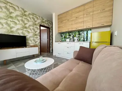 a living room with a couch and a table at Romantic Getaway 1-BD Apartment with Sea View by Flat Mаnаger in Sozopol