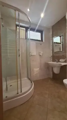 a bathroom with a shower and a sink at Апартамент Лагуна Aйланд in Sozopol