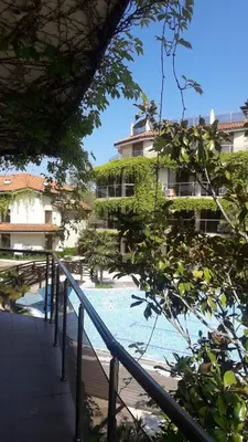 a resort with a swimming pool and a building at Апартамент Лагуна Aйланд in Sozopol
